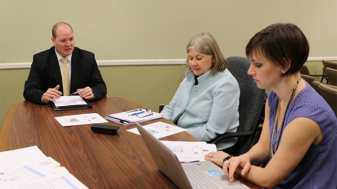Jay Owens, doctor of education candidate, presents his Education Leadership Portfolio to Joan Buttram and Elizabeth Farley-Ripple.