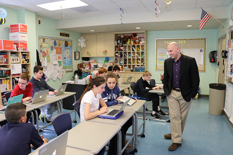 Joshua Wilson works with students at The College School