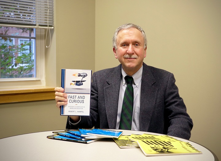 School of Education professor Robert Hampel displays his latest book Fast and Curious: A History of Shortcuts in American Education