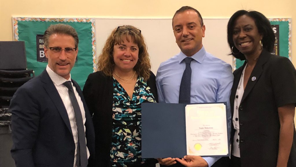 UD alumnus Nader Makarious is honored at the June 2018 Brandywine School District (BSD) board meeting. Pictured from left to right is Mark Holodick, superintendent of BSD, Michelle Kutch, supervisor of STEM, Science, and Social Studies at BSD, and Teri Quinn Gray, co-chair of the Delaware STEM Council.