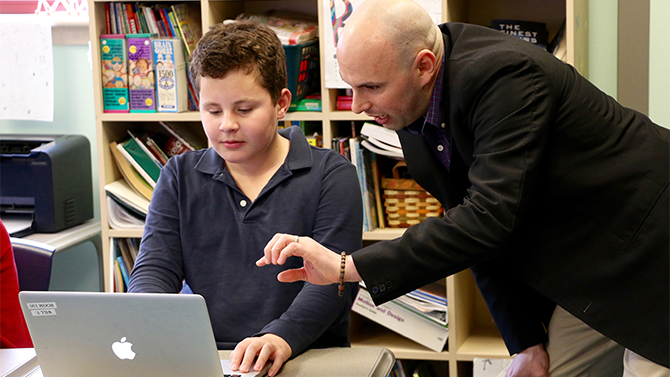 Professor Josh Wilson reviews work with a student.