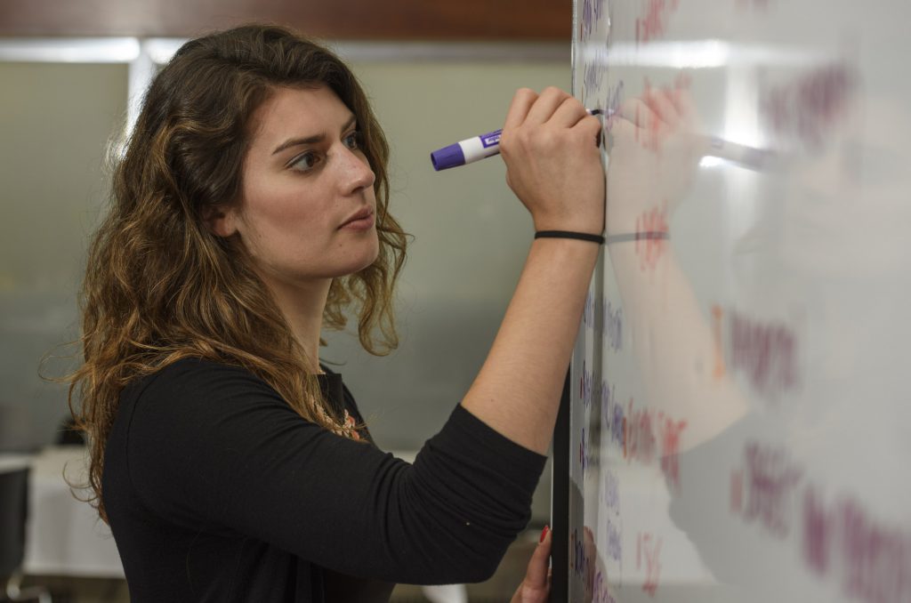 Student writes on whiteboard
