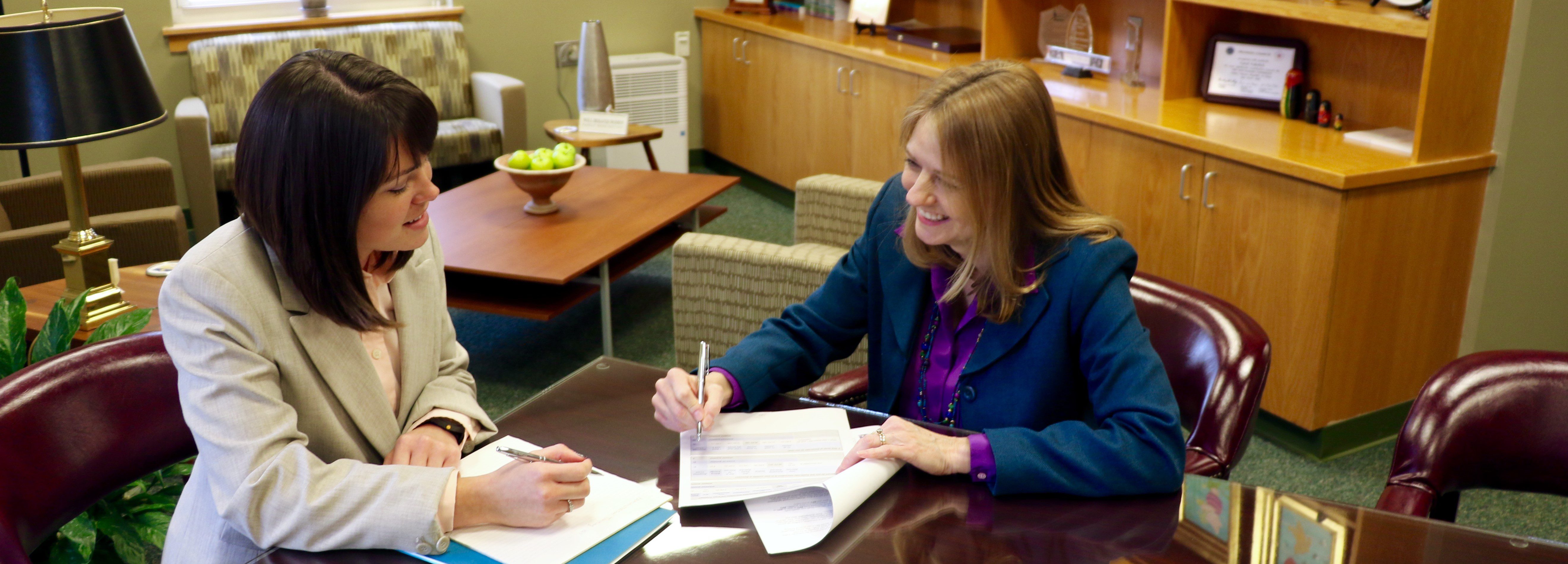 A CEHD advisor meets with a student in her office to discuss program offerings and course schedules.