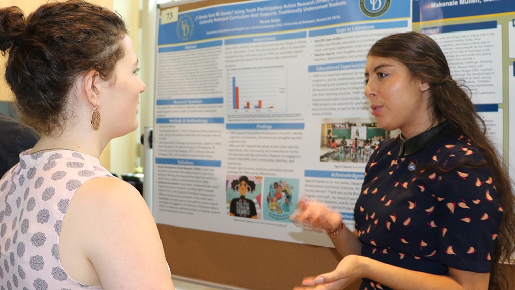 CEHD undergraduate student presents her summer research at a poster session.