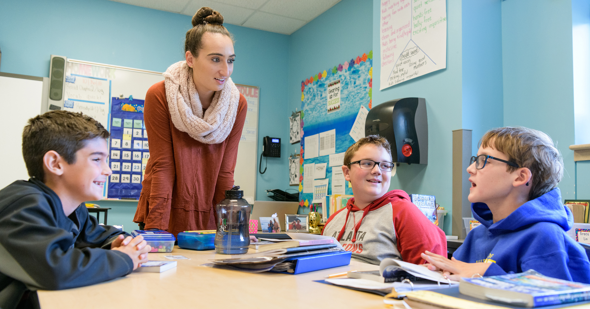 A student teacher in UD's ETE program works with children around a classroom table on CEHD's Children's Campus.