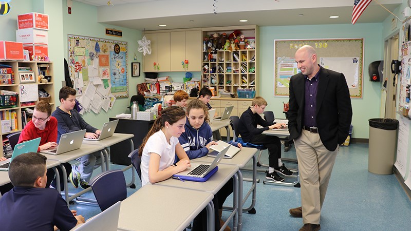 Joshua Wilson works with students at The College School