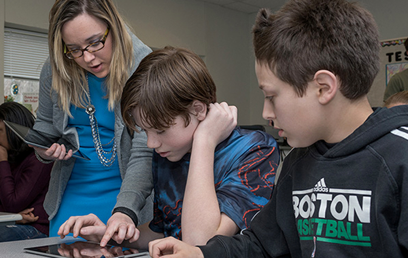 Doctoral student engages in research activity with two children