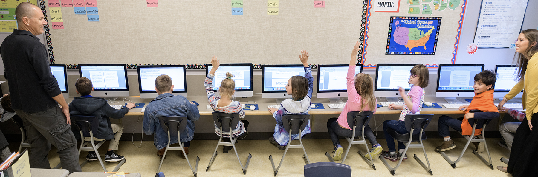 Two teachers at The College School help students