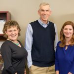 Three University of Delaware School of Education professors are 2019 AERA Fellows. From left to right: Roberta Golinkoff, James Hiebert, and Laura Desimone. They stand in front of bookshelves in one of their UD offices.