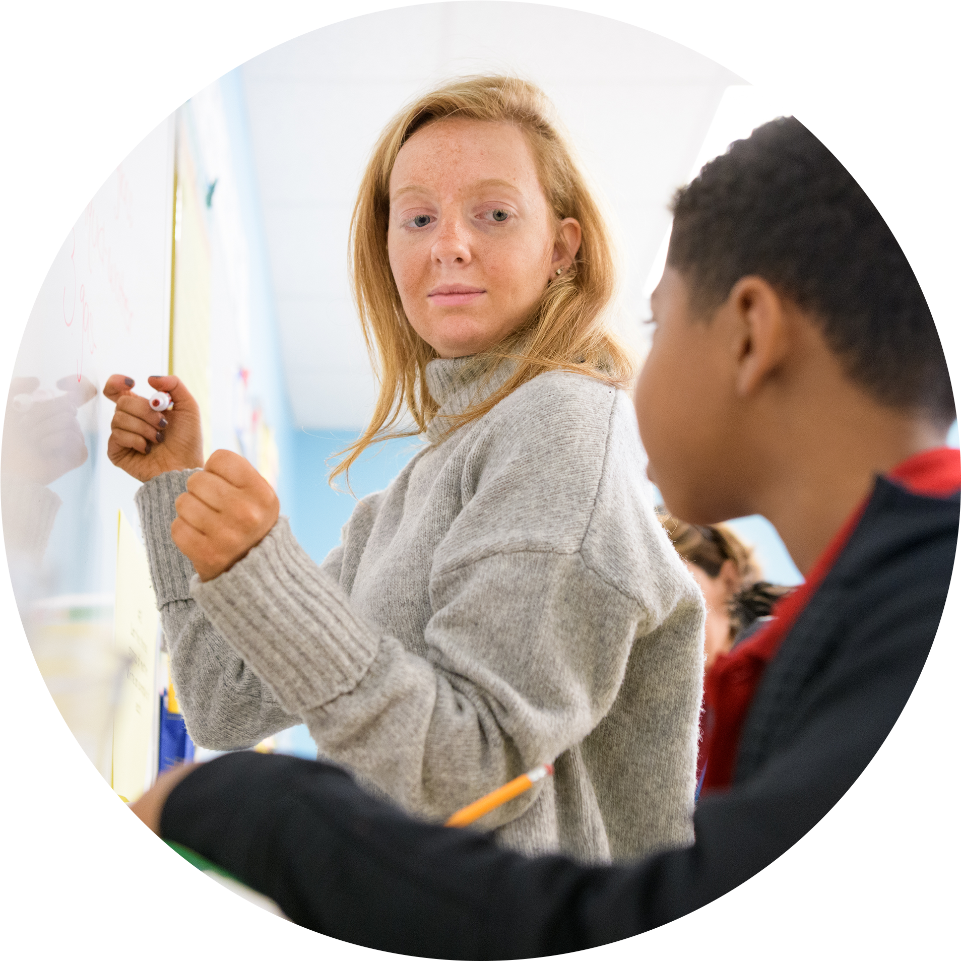 A teacher and student at a whiteboard.