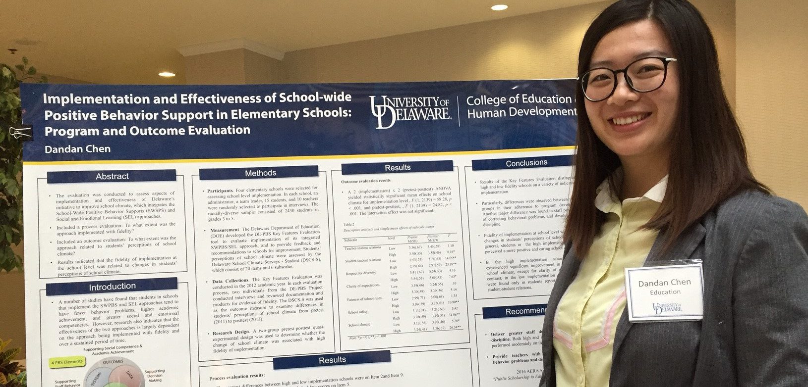 Doctoral student presents research in evaluation, measurement, and statistics with a poster at a college symposium.