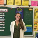 Elementary teacher education alumna poses for a photo in her elementary classroom.