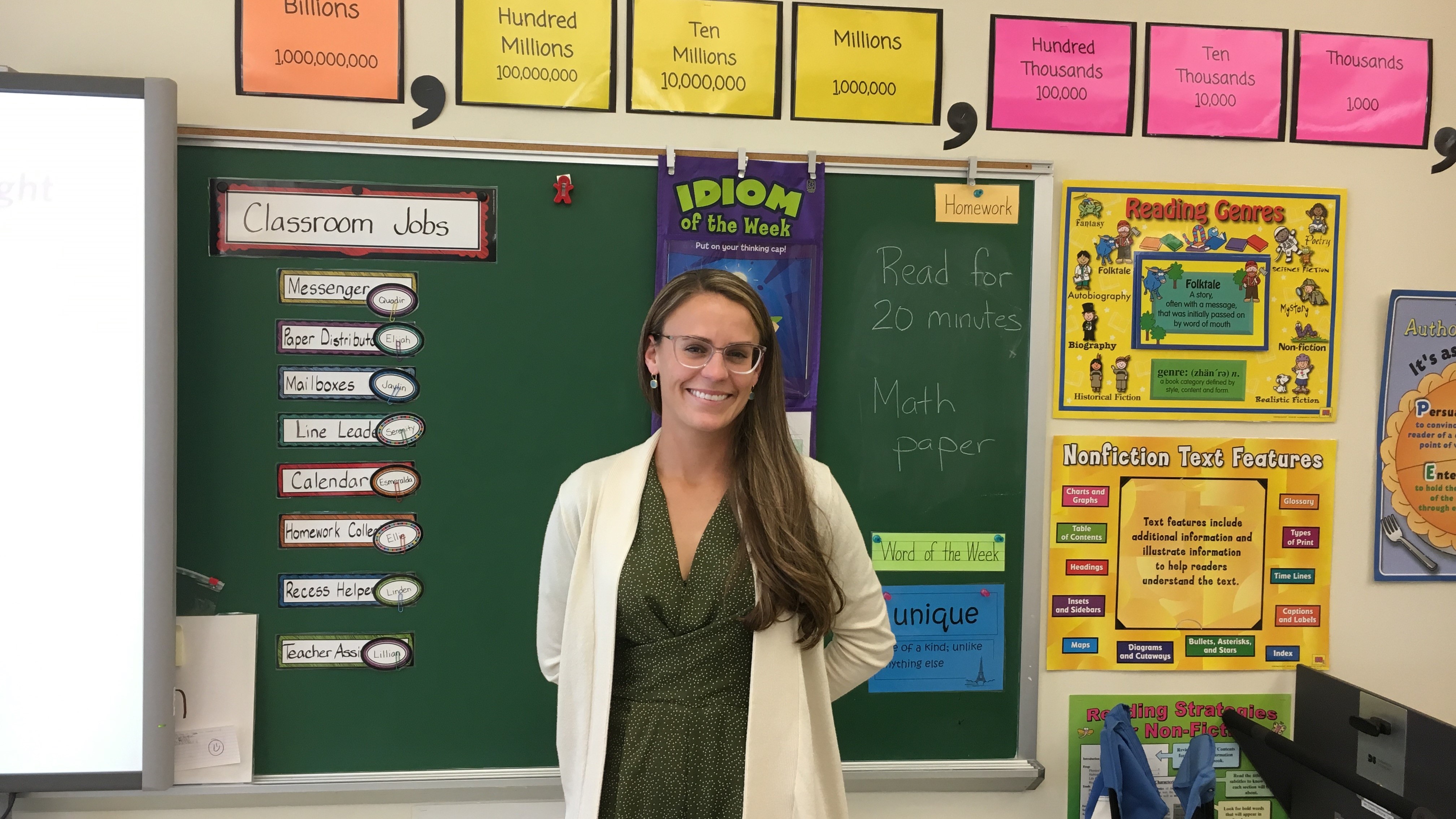Elementary teacher education alumna poses for a photo in her elementary classroom.