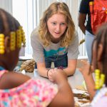 UD student Ashley Warokomski shows students at West End Neighborhood House how to make “slime” using glue, glitter and other materials, as they experiment with how varying the ratio of ingredients changes the result.