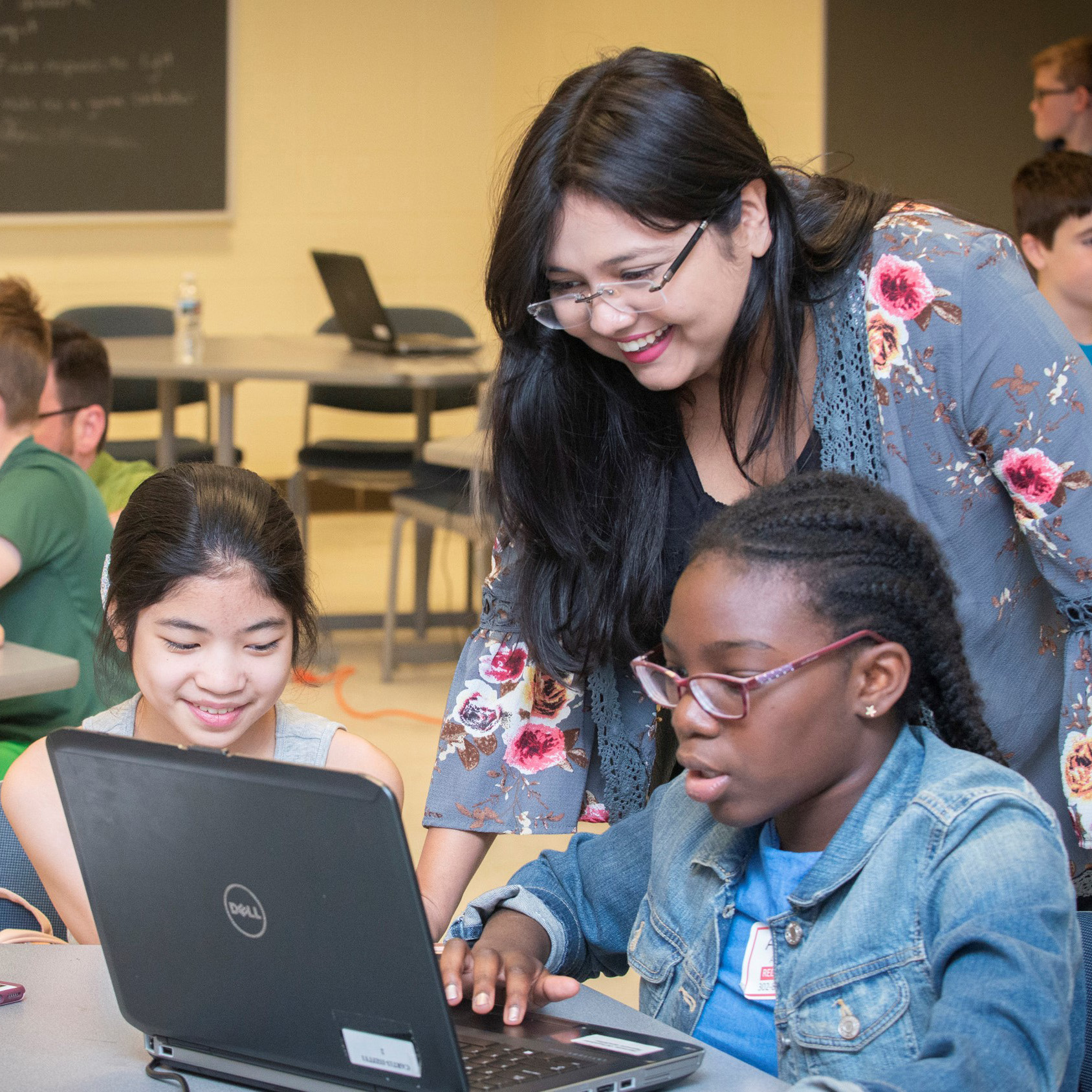 Teacher working with student on computer