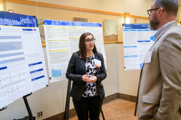 graduate student presents their research to faculty at steele symposium